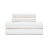 A stack of ivory white sateen sheets folded neatly on top of each other