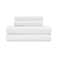 A stack of ivory white sateen sheets folded neatly on top of each other